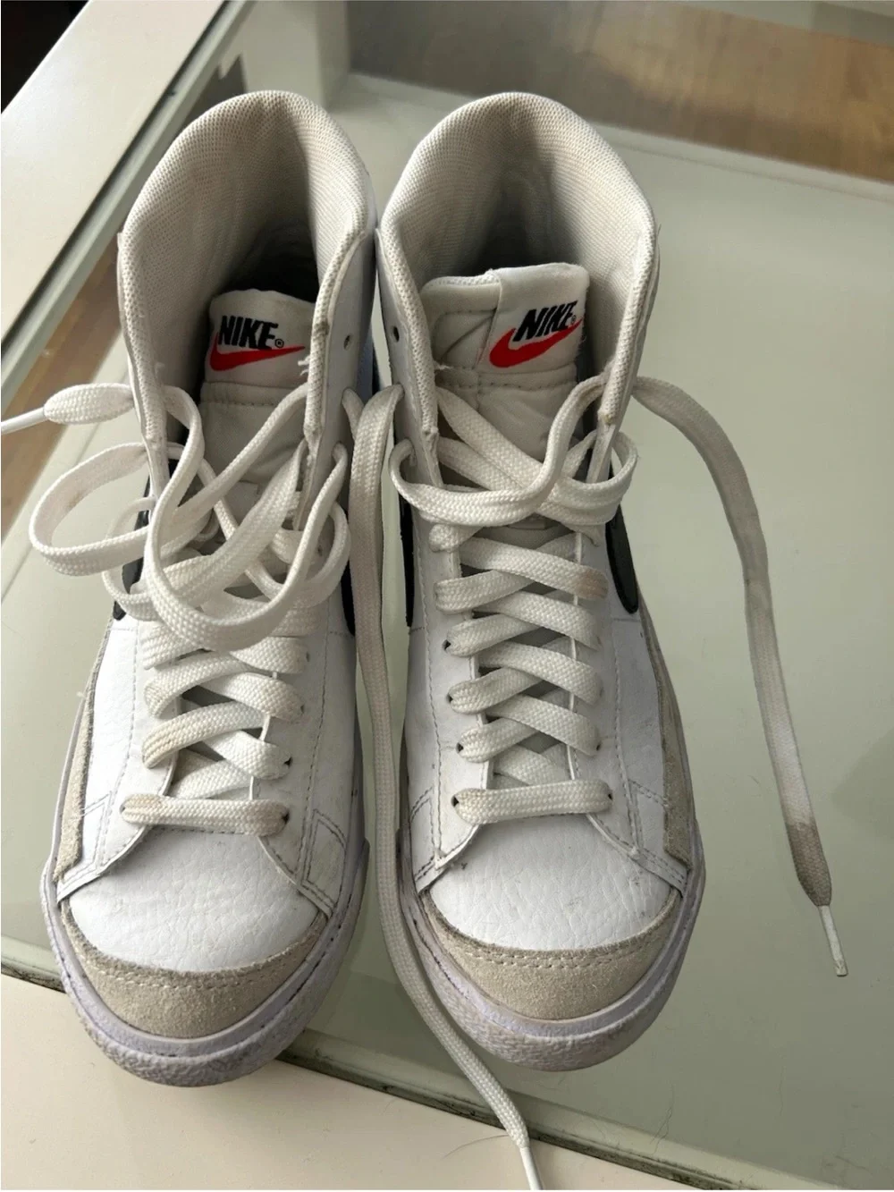 Nike White High-Top Sneakers with Black Swoosh and Red Logo
